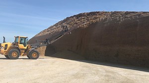 How do we get the silage out of our piles so that it can be mixed for feeding? Good question! The silage is carefully shaved off our piles with an attachment on a pay loader as needed. Keeping the open face of the piles well-shaven and maintained is crucial to preventing it from collapsing. #TheYearofWhy #PileItUp | Milk Source, LLC