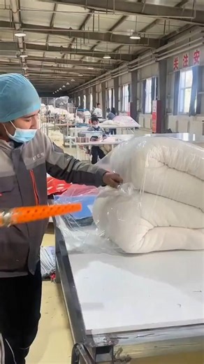 Factory process compresses plush wrapping mattress with care