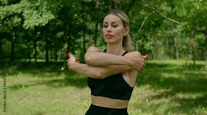 Athletic fit blond pretty woman doing fitness exercises training full body core muscles working out outdoors. Warming up before the training. Self isolation. Self development. Sports and workout.