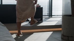 Woman in a robe walking in a modern bathroom | Free Stock Video Footage