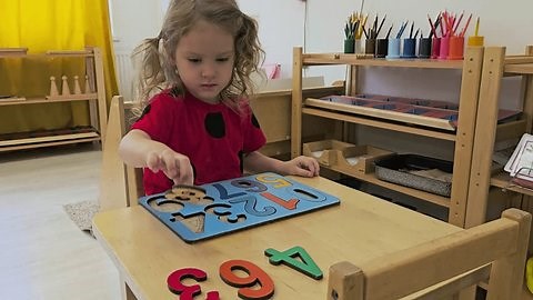 clip-3966508537-little-girl-playing-number-puzzle-has-numbers