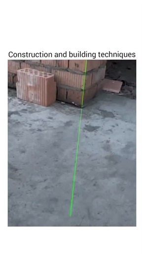 @gearheadgiggle on Instagram: "The video shows a construction worker using a laser level tool to ensure the vertical alignment of a brick wall. At the beginning, a voice says "拿下来" (Take it down), likely instructing someone to remove or adjust a component. The laser level projects a bright green vertical line along the wall, serving as a precise reference for maintaining straightness during construction. The camera slowly pans upward, following the laser line, revealing the top of the wall, a wo