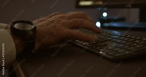 male hands press on backlit computer keyboard in dark room and stop. stupor. close-up anxiety