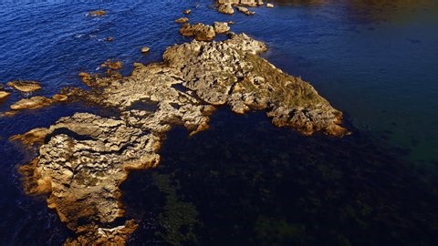 clip-3982771145-stunning-rocky-coastline-emerges-deep-blue-sea