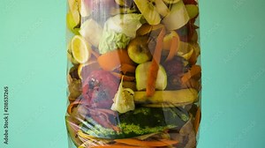 Food waste. Compostable food scraps. Organic kitchen waste for compost with vegetables, fruits and varied food. Filling garbage bag time lapse