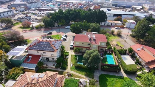Houses with swimming pool and solar panels in residential neighborhood, aerial