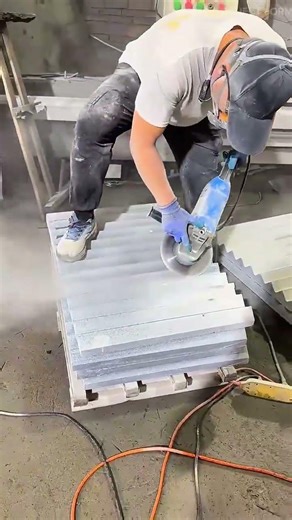 Cutting stone blocks with a grinding machine then polishing surfaces using water