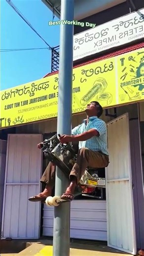 The process of climbing a pole using a homemade lift powered by a gasoline motor