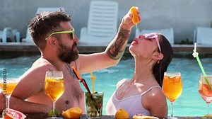 Enjoying pool party with friends. Happy attractive young friends in sunglasses are having fun in swimming pool. Group of friends together in the swimming pool leisure.