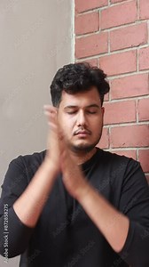 person is rubbing his hand palms and placing on the closed eyes after yoga and pranayam. rubbing makes the palm warm, placing them on eyes make the eyes relaxed, destressed, increase blood circulation