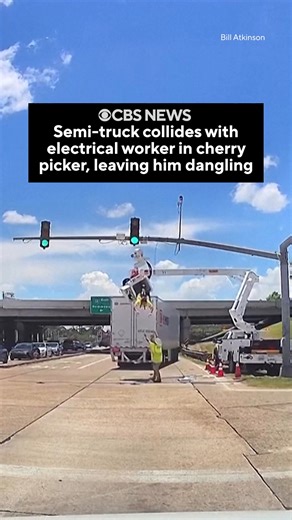 64M views · 260K reactions | Dashcam footage shows the moment a semi-truck collided with an electrical worker that was working in a cherry picker at a traffic light in Denham Springs, Louisiana, leaving the worker dangling upside down in broken equipment. The worker, who was attached to a safety harness, escaped the June 25 incident uninjured. | CBS News | Facebook