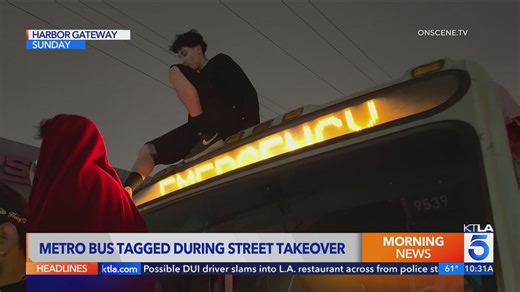 Street takeover crowd climbs on, tags Metro bus in South Los Angeles