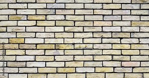 Video background of light yellow brick wall. Texture of a brick wall. Modern wallpaper design for web or graphic art projects. Abstract background for social media, banners or presentations