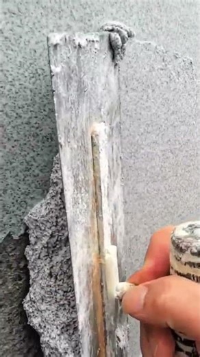 Applying liquid granite texture coating to exterior wall surface using specialized trowel technique