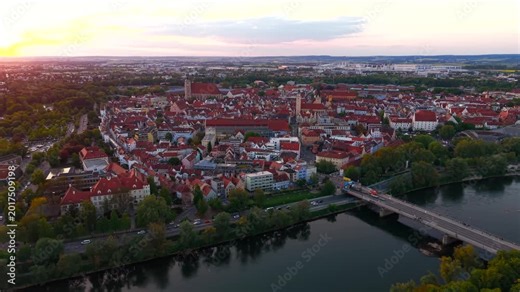 Aerial view of Ingolstadt city center in Germany during summer evening. Historic district, Danube waterfront and scenic Bavarian skyline at sunset.