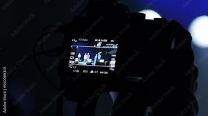 Behind the scene of tv movie video film shooting production and camera lighting set. Media. Cameraman working with announcer in. Professional digital video camera on work