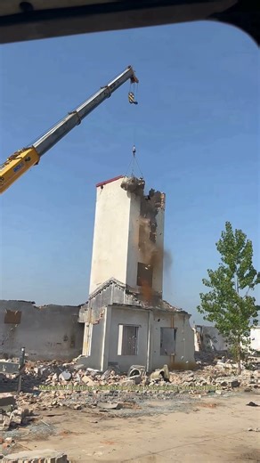 They Using A Crane And Mesh Sling To Demolish An Old Building