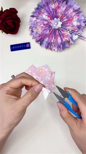 Fold spring into paper and make a super fairy cherry blossom paper fan DIY. Just a few pieces of