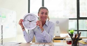 Woman with a large round wall clock in office. Employee manager and time management at work