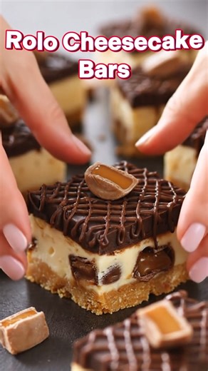 Rolo Cheesecake Bars 🍫✨ These Rolo Cheesecake Bars are thick, creamy, chocolate-drizzled heaven with gooey caramel tucked into every bite. That buttery graham cracker crust, rich cheesecake filling, and glossy chocolate topping make this the kind of bakery-style dessert everyone fights over. If you love chocolate and caramel together, save this Rolo Cheesecake Bars recipe now and tag a friend who needs a square (or three). 😍 Yield: 12 large servings Ingredients: • 1 1/2 cups graham cracker cru