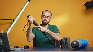 Videographer recording tutorial of monopod for professional content creators. Professional studio video and photo equipment technology for work, photo studio social media star and influencer