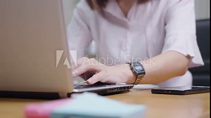 Female short hair employee contemplated staring at computer screen before typing on keyboard inside office room, businesswoman sit down and working on a modern wireless laptop at remote workplace