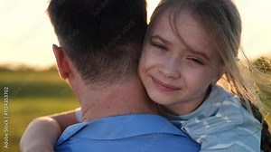 Girl hugging her father sunset, Daughter embracing dad outdoors, Child father bonding nature, Loving hug between father daughter, portrait face Little girl cuddling her dad, Father daughter sunset