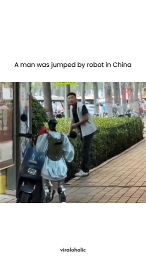 VIRAL VIDEOS on Instagram: "This video captures a bizarre and comedic encounter on a busy sidewalk, captioned "A man was jumped by robot in China" to highlight the unexpected intersection of advanced technology and public pranks. In the footage, a small, bipedal robot wearing a blue hoodie and a backpack approaches a man on a moped and begins humorously "sparring" with him using oversized red boxing gloves. It generated 3.2M views and 480K likes by leaning into the "future is now" aesthetic with