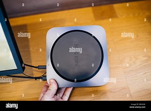 PARIS, FRANCE - NOV 7, 2018: Man holding the rear part of the new Apple Mac Mini computer with the new processor cpu, 64 DDR4 RAM and 10 Gigabit Ethernet port Stock Photo - Alamy