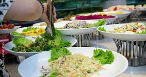 buffet various salad options. Close-up of canapes, vegetables and herbs on a banquet table.