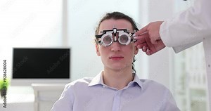 Eye examination using a trial lens at an optometrist clinic