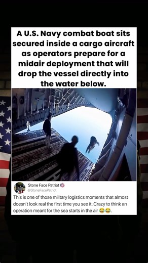 A U.S. Navy combat boat sits secured inside a cargo aircraft as operators prepare for a midair