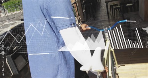 Hand gripping blue handlebars activating data charts and map as rider pushing bicycle toward patio