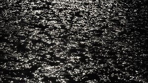 Dark water surface at night. Video footage of dark freezing water.