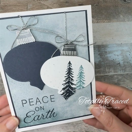 ✨ Day 15: Color Challenge ✨ These colors bring such a sense of calm and serenity! The soft background paired with bold ornaments creates a peaceful winter vibe. I especially love the stamped trees on the ornament—they add the perfect touch of nature. 🎥 Watch as these soothing tones come together for a card that truly says Peace on Earth. #ColorChallenge #PeaceOnEarth #HandmadeCards #StampinUp #TotallyTraced #30daychristmascardmakingchallenge | Totally Traced