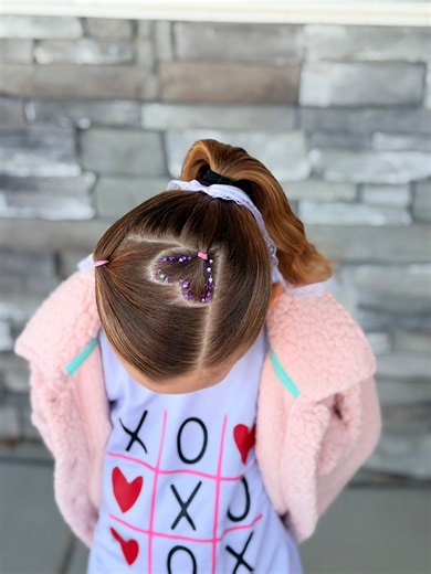 This fun ponytail hairstyle is perfect for this time of year. So cute with the little accent heart and hair glitter gel. #valentinesday #valentinesdayhairstyle #hairstyle #girlshairstyles | Easy Toddler Hairstyles