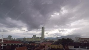George Town city skyscrapper view in rain season HD time lapse. Penang, Malasya. Clouds and mountains on background.