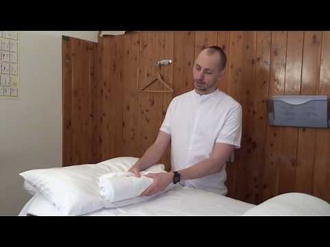 Towel roll with pillow to sleep better with neck pain