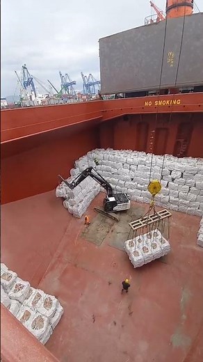 Cargo ship loading cement in bags.