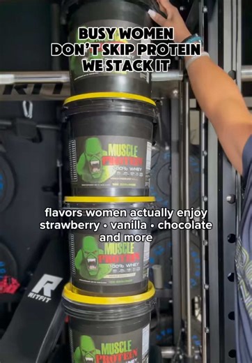 Protein supplement support for busy moms and active women. In this garage gym clip, Ze stacks multiple buckets of Colossal Labs Muscle Whey Protein to show how preparation stays part of her fitness routine. When schedules fill up with work, family responsibilities, and workouts, keeping a dependable protein supplement nearby helps her stay consistent with daily nutrition. Each scoop provides 25 grams of protein with zero sugar, giving her body the building blocks needed to support muscle develop