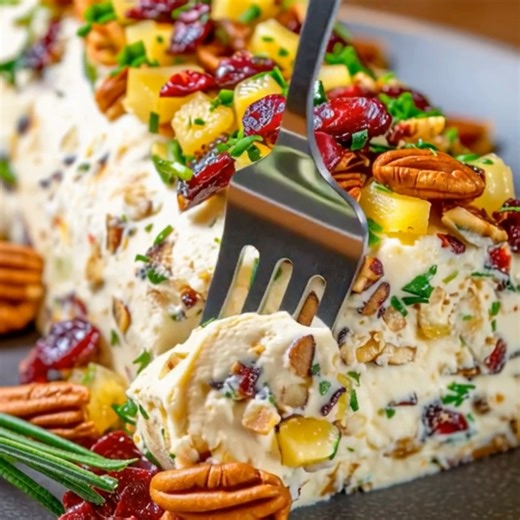 Pineapple Cranberry Holiday Cheese Log Festive Cheese Log with Pineapple and Cranberries Ingredients: 1. 8 oz cream cheese, softened 2. 1 cup shredded sharp cheddar cheese 3. 1/2 cup crushed pineapple, drained 4. 1/2 cup dried cranberries, chopped 5. 1/4 cup green onions, chopped 6. 1/2 cup chopped pecans 7. 1 teaspoon garlic powder 8. 1 teaspoon onion powder 9. Salt and pepper to taste 10. Fresh parsley for garnish Directions: Prepare the Cheese Mixture: 1.1. In a large bowl, mix the softened c