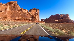 Arches National Park. The Arches National Park Scenic Drive is a 36-mile, out-and-back paved road that showcases the park's iconic red rock formations, including Balanced Rock and the Windows Section. The drive is the park's primary auto-touring route and includes numerous pullouts for viewpoints and trailheads to major attractions like Delicate Arch. Allow at least 1.5 hours for a short drive, or 3 hours or more for a comprehensive tour with stops, and be aware that timed-entry reservations may