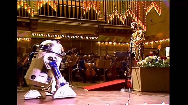 It's April 29, 1980. You sit down to watch the first John Williams-led Boston Pops performance at Symphony Hall. Suddenly, C-3PO and R2-D2 appear... May the force be forever and always with you, JW! Happy 90th, Maestro! 🎉🎶 | GBH