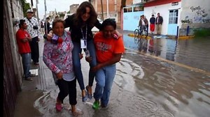 TV Reporter Fired After She's Pictured Being Carried Over Floodwaters to Keep Shoes Clean