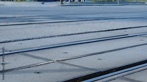 Low angle view as transit train rolls past on urban railroad tracks