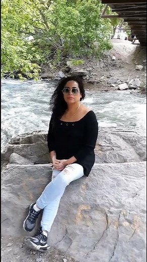 Charming Woman's Outdoor Adventure: Exploring Scenic Landscapes and Mountain Views