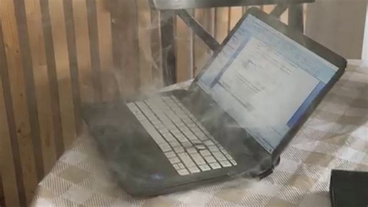 Terrifying moment laptop spontaneously catches fire at home