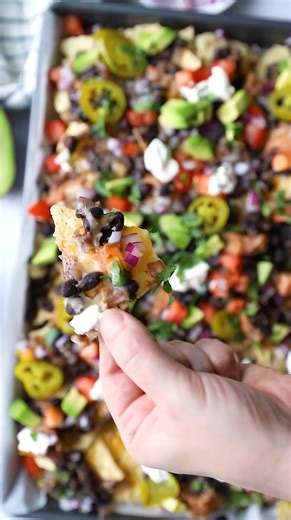 This Vegetarian Nachos Recipe is a delicious weeknight dinner or party appetizer that whips together in less than 30 minutes! These veggie nachos are cheesy, loaded with toppings, and irresistibly crunchy. Ingredients 1 tablespoon of olive oil ½ of an onion diced 2 garlic cloves minced 1 can of black beans drained but not rinsed ½ teaspoon of cumin ½ teaspoon of salt freshly ground pepper to taste ½ teaspoon of chipotle powder ¼ cup water or veggie broth for added flavor 1 bag tortilla chips 4 c