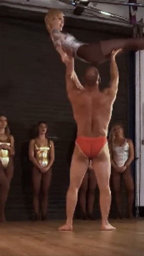 Bodybuilder presses woman overhead with ease