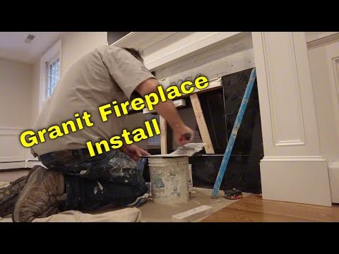 Black granite tile install, gas fireplace. #howtotile #tile #fireplace